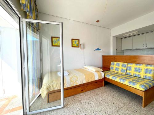 a bedroom with a bed and a sliding glass door at GoettenMar Platja d'Aro in Platja  d'Aro
