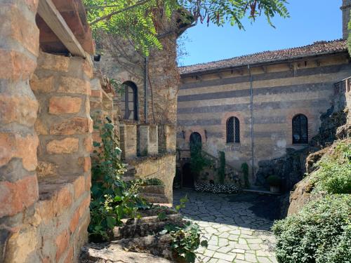 an old stone building with a brick wall at Torre del Barbagianni - Castello di Gropparello in Gropparello