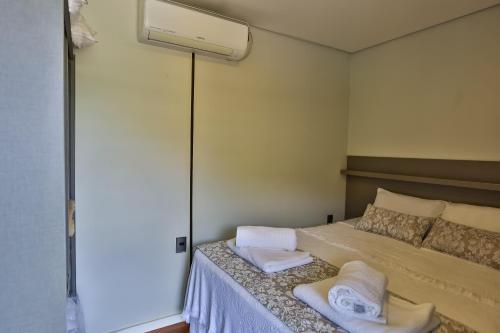 a bedroom with a bed with two towels on it at Hotel Fazenda Terra dos Sonhos in Bueno Brandão
