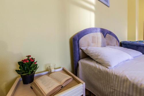 a room with a bed and a table with a book at Однокімнатні апартаменти на Майдані, дистанційне заселення 24х7 in Kyiv