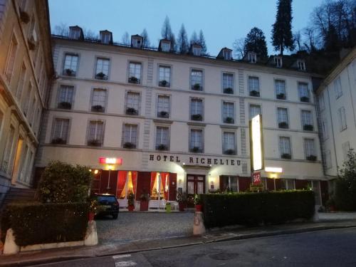 a hotel in the middle of a street at Hotel Richelieu in Eaux-Bonnes