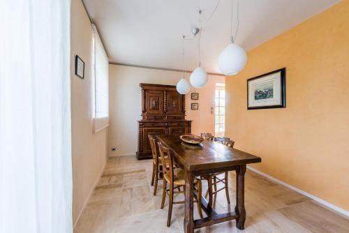 a dining room with a wooden table and chairs at Hôtel-Restaurant le Château de Besseuil, Mâcon Nord - Teritoria in Clessé