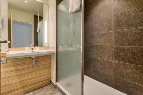 a bathroom with a sink and a shower at Campanile Saint Jean de Luz in Saint-Jean-de-Luz