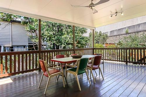 a wooden deck with a table and chairs on it at Walk to the Charming Character Home in Brisbane