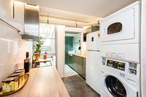 a laundry room with a washer and dryer at Restful Room in the City with Rooftop Terrace in Perth