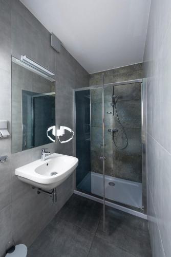a bathroom with a sink and a shower at Balans Studio Old Town in Gdańsk