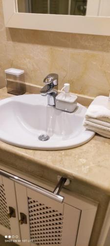 a white sink in a bathroom with a mirror at Ground floor with view by Bev in San Javier