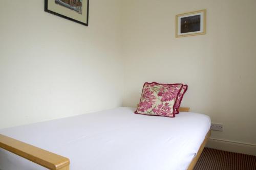 a bed with a pillow sitting on top of it at Charming City Centre Flat in Edinburgh in Edinburgh