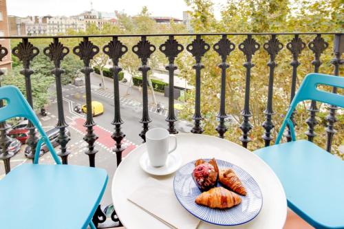 a table with a plate of food on a balcony at Design 1 Bedroom Apartment near Plaza España in Barcelona