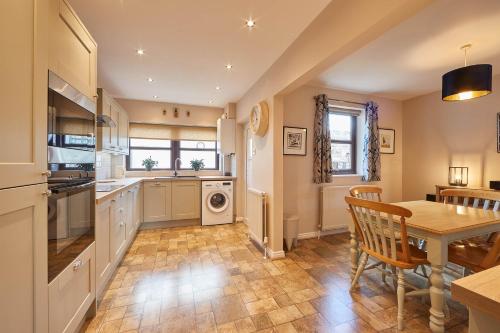 a kitchen with a table and a dining room at Host & Stay - Wood Street Cottage in Barnard Castle