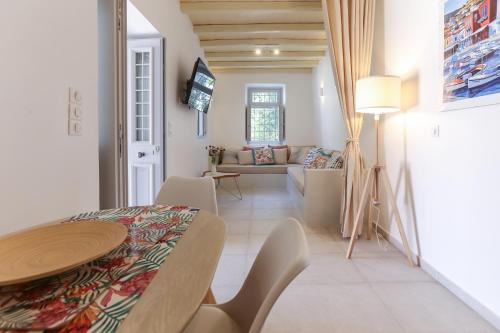 ein Esszimmer und ein Wohnzimmer mit einem Tisch und Stühlen in der Unterkunft La Maison de Marie Geraldine in Hydra