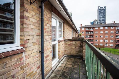 ロンドンにあるModern and Spacious Central 1 Bedroom Apartment with Balconyのレンガ造りの建物のバルコニー(窓付)