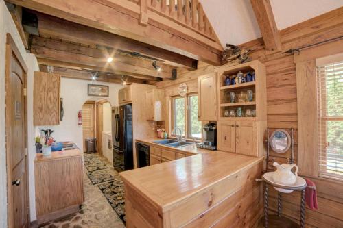 a kitchen with wooden cabinets and a large counter top at Relaxing Equestrian Retreat With Full Amenities in Tryon