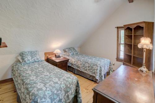 a bedroom with two beds and a table and a window at Relaxing Equestrian Retreat With Full Amenities in Tryon