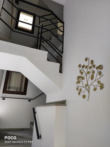 a spiral staircase in a house with a tree sticker on the wall at Casa Rural Lavernia in Cabanes