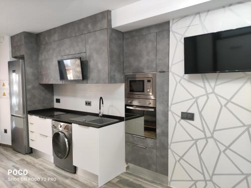 a kitchen with a sink and a microwave at Casa Rural Lavernia in Cabanes
