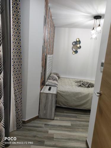 a small bedroom with a bed and a table at Casa Rural Lavernia in Cabanes
