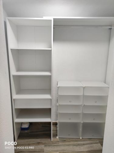 a closet with white shelves and a mirror at Casa Rural Lavernia in Cabanes