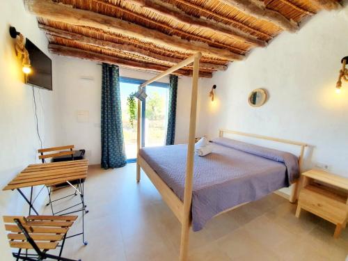 a bedroom with a bed and a wooden ceiling at B&B La Nava Suites in Mojácar