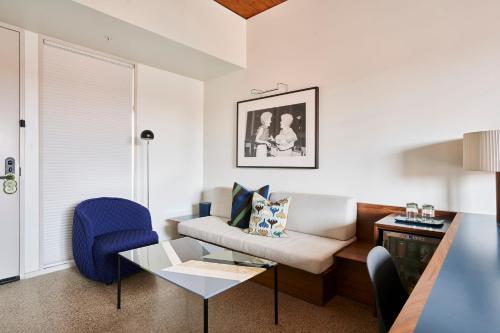 a living room with a couch and a table at Hotel Magdalena in Austin