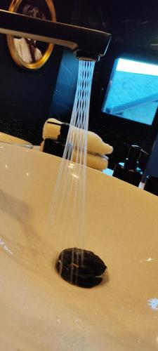 a stream of water is coming out of a sink at Mas d'en Roqueta CASA in Aravell