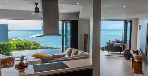 a living room with a view of the ocean at Tamarind Hills Resort & Villas in Johnsons Point