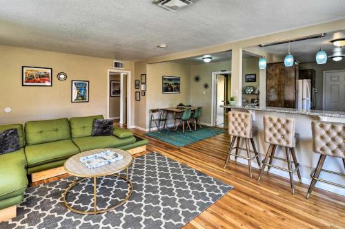 a living room with a green couch and a kitchen at Vintage Downtown Vegas Retreat Less Than 3 Mi to Strip! in Las Vegas