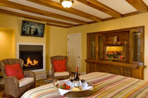 a living room with a bed and a fireplace at Channel Road Inn, A Four Sisters Inn in Los Angeles