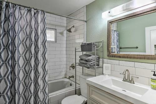 a bathroom with a sink and a tub and a toilet at Vintage Las Vegas Oasis Less Than 3 Mi to the Strip! in Las Vegas