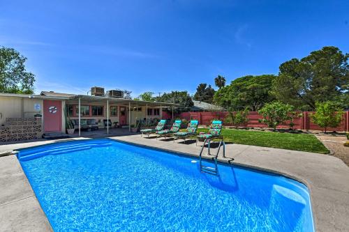 a swimming pool with chairs and a house at Vintage Las Vegas Oasis Less Than 3 Mi to the Strip! in Las Vegas
