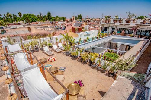 a beach scene with a couple of people sitting on chairs at Riad Villa Almeria Hotel & Spa in Marrakesh