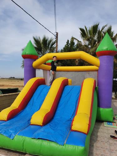 a young boy is standing on a inflatable play structure at Larnaca Mansion Ideal for 3 Families or more in Larnaka