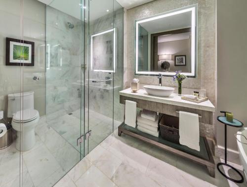 a bathroom with a sink and a glass shower at InterContinental Real Santo Domingo by IHG in Santo Domingo
