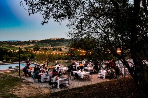 a group of people sitting at tables at a restaurant at LaChiusa Tuscany in Montefollonico
