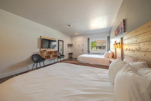 a bedroom with two beds and a television in it at Kanab Suites in Kanab