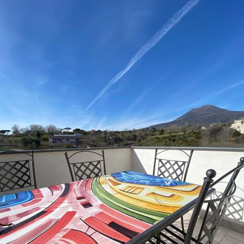 a table on a balcony with a view of a mountain at Villa Manzo relais -Pompei Vesuvius in Boscotrecase