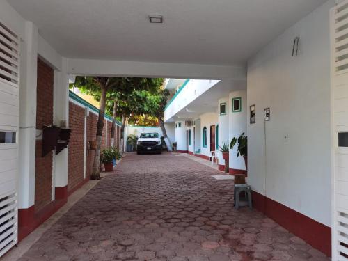 an alley with a car parked in a building at Hotel Gamito in Puerto Escondido