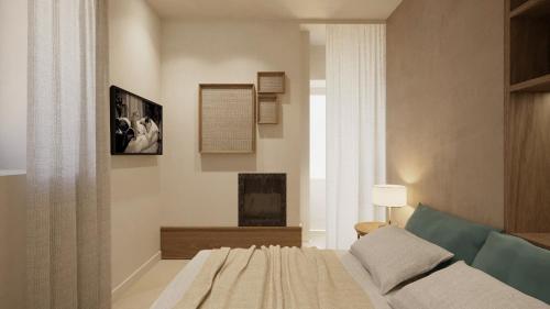 a bedroom with a bed and a fireplace and a window at Relais San Giuliano in Viagrande