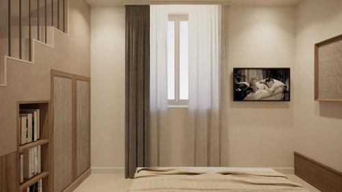 a bedroom with a bed and a window with a tv at Relais San Giuliano in Viagrande