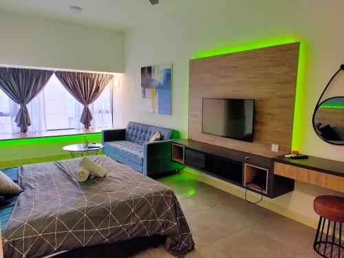 a living room with a bed and a tv at Imperio Residence Bathtub Studio at Malacca Town-Near JONKER STREET in Melaka