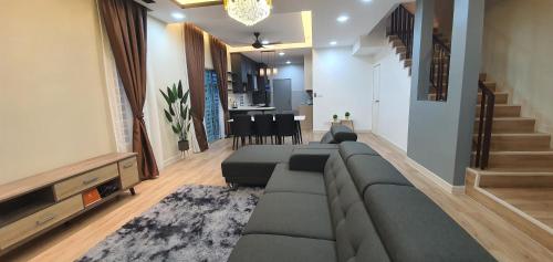 a living room with a couch and a dining room at Villa with private Pool and Sauna @ Nilai in Nilai
