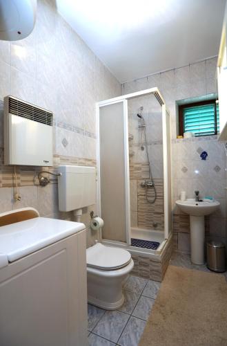 a bathroom with a shower and a toilet and a sink at Apartment Sea relief in Šibenik