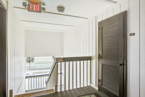 a hallway with a door and a balcony at Oceanside 301-A in Isle of Palms