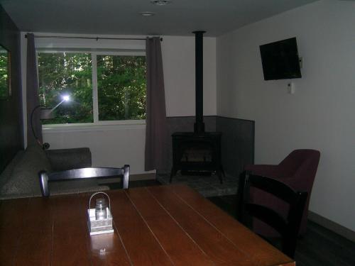 a dining room with a table and a fireplace at Green Mountain Cabins in Killington