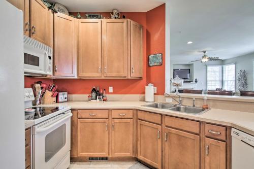 a kitchen with wooden cabinets and a sink at 4 Mi to Bethany Beach Sunny Escape with Porches! in Ocean View