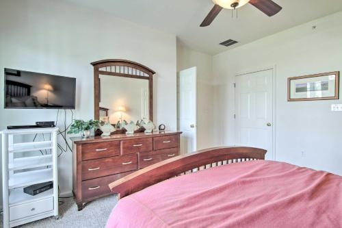 a bedroom with a bed and a dresser with a mirror at 4 Mi to Bethany Beach Sunny Escape with Porches! in Ocean View