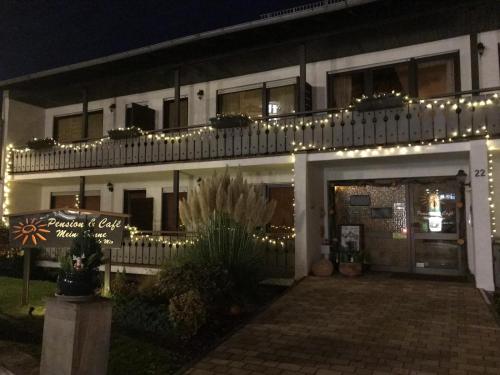 a building with christmas lights on top of it at Pension & Café Meine Sonne Sole Mio in Bad Sooden-Allendorf