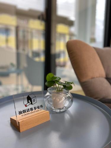 a table with a glass bowl and a sign on it at Summer Grass B&B 台東縣民宿1729號 in Taitung City