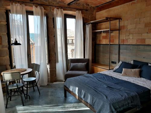 a bedroom with a bed and a table and chairs at Casa Boutique nº 24 in Cardona