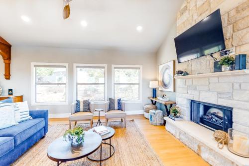 a living room with a blue couch and a fireplace at Lago Vista Retreat in Lago Vista